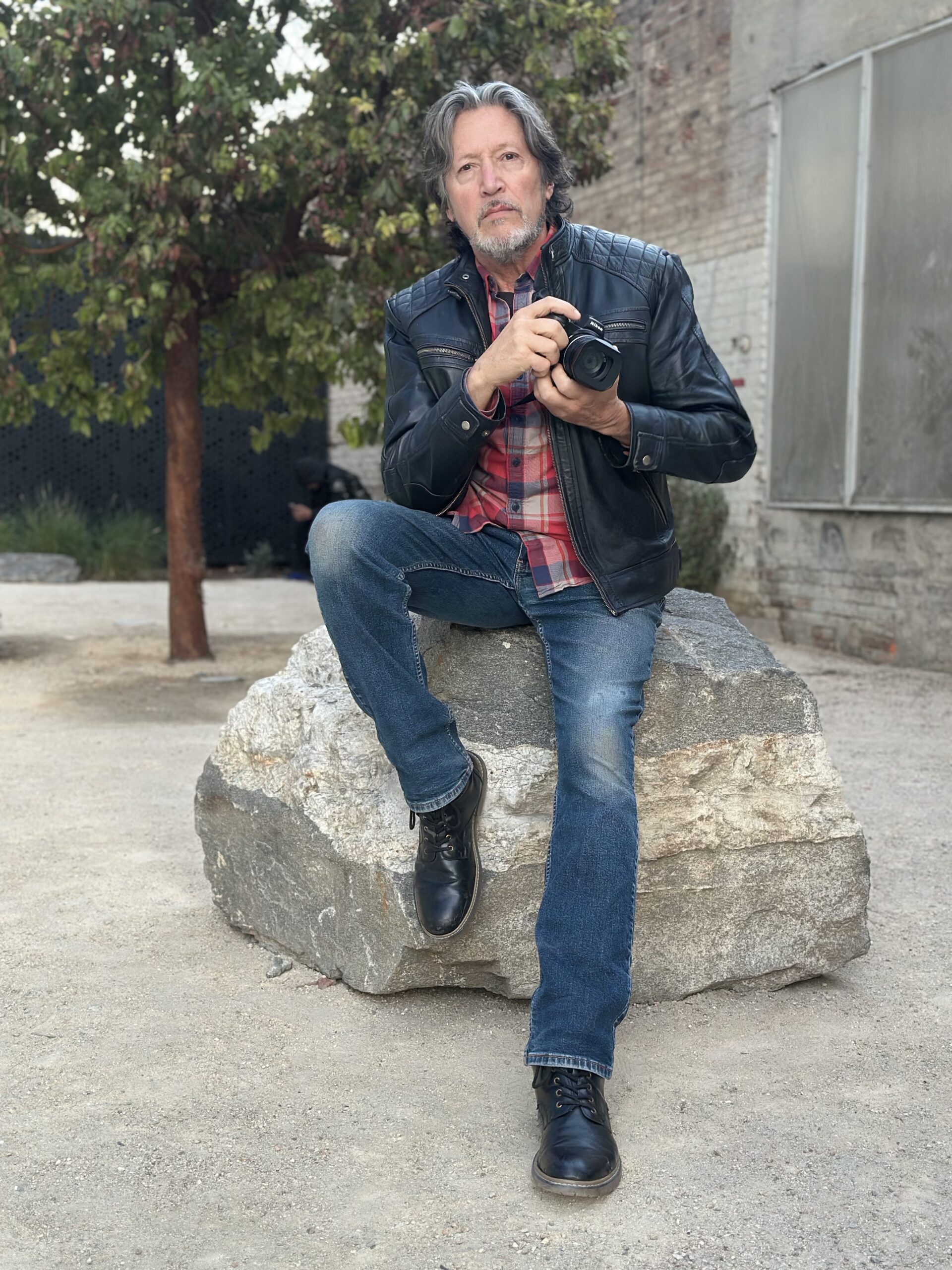 Jean-Pierre Vanhoegaerden sitting on a rock in the DTLA district